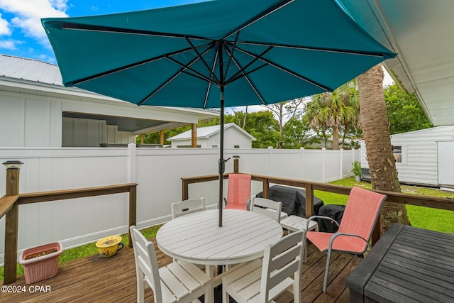 wooden terrace with a storage shed