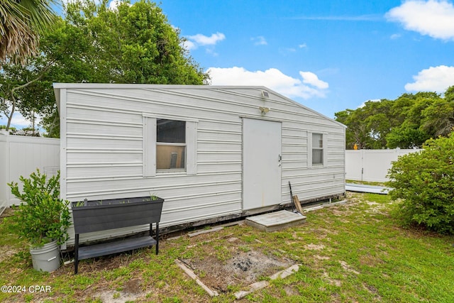 view of outbuilding featuring a lawn