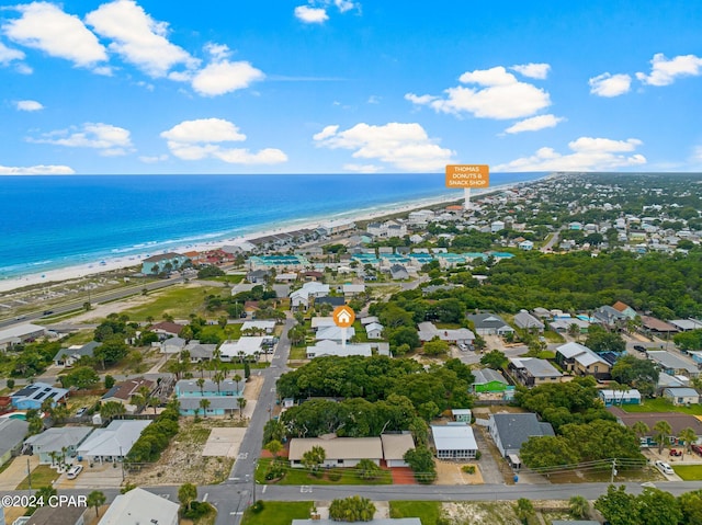 drone / aerial view with a water view and a beach view