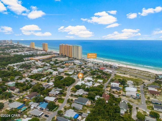 drone / aerial view featuring a water view and a beach view