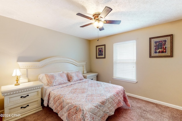 bedroom with a textured ceiling, carpet flooring, and ceiling fan