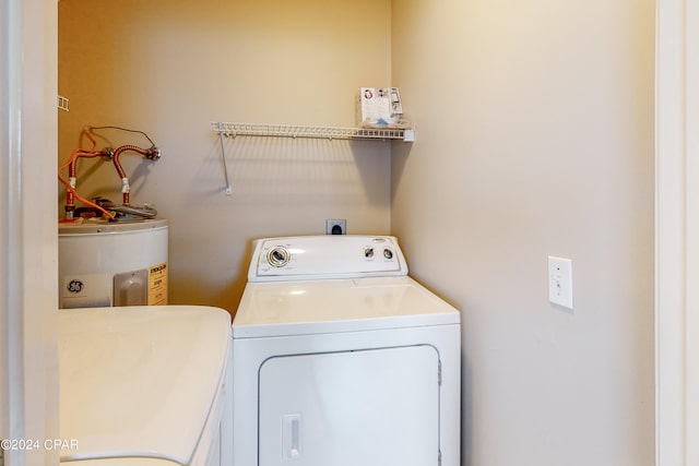 laundry room featuring washing machine and clothes dryer and electric water heater