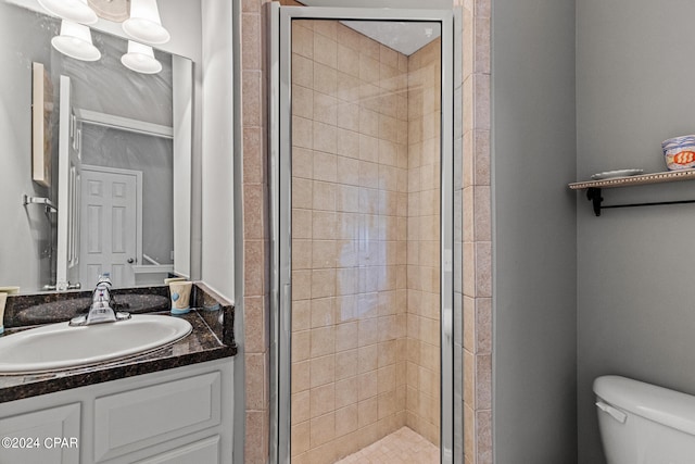 bathroom featuring walk in shower, toilet, and large vanity