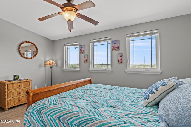 bedroom with ceiling fan and hardwood / wood-style flooring