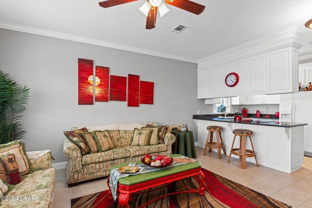 tiled living room with sink, ornamental molding, and ceiling fan