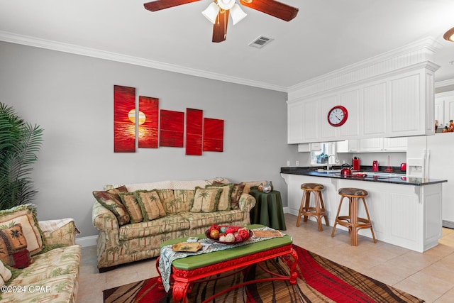 living room with light tile patterned floors, visible vents, a ceiling fan, and crown molding