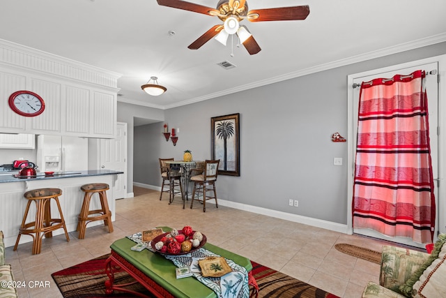 tiled living room with ceiling fan and crown molding