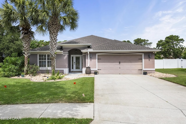 view of front facade featuring a front lawn and a garage