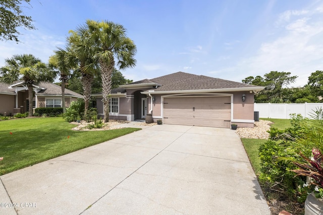 view of front facade with a front yard and a garage