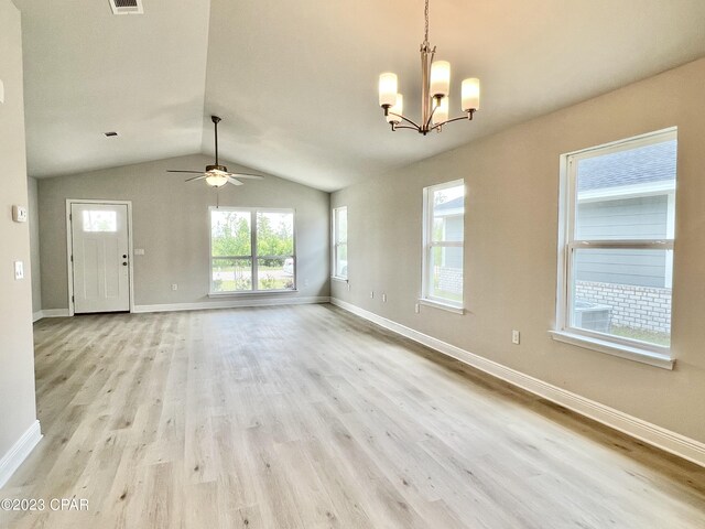 interior space featuring vaulted ceiling, light hardwood / wood-style flooring, and ceiling fan with notable chandelier