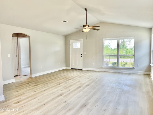 unfurnished living room featuring ceiling fan, light wood-type flooring, and vaulted ceiling