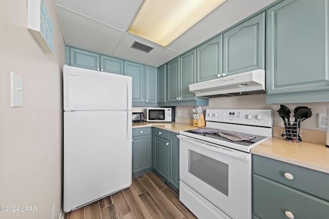 kitchen with a drop ceiling and white appliances