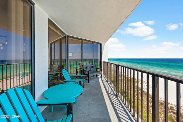 balcony featuring a water view and a view of the beach