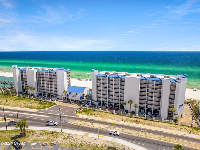 drone / aerial view featuring a water view and a beach view