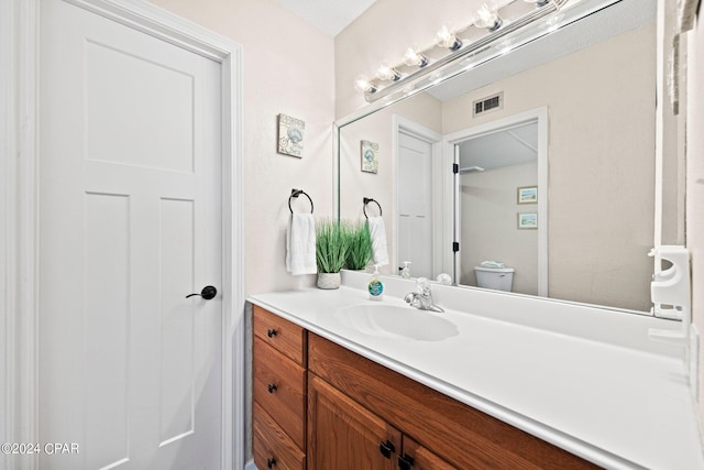 bathroom with toilet and vanity