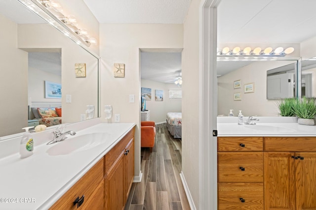 bathroom featuring ceiling fan, vanity, and a textured ceiling