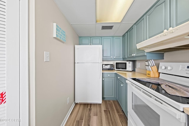 kitchen featuring hardwood / wood-style flooring and white appliances