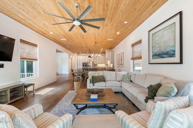 living room with a healthy amount of sunlight, dark hardwood / wood-style floors, wood ceiling, and ceiling fan