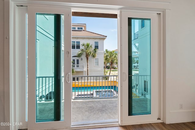 doorway with hardwood / wood-style floors and a wealth of natural light