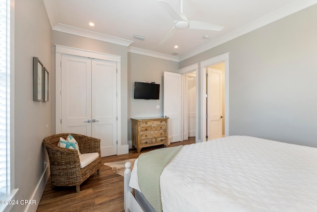 bedroom with dark hardwood / wood-style floors, ceiling fan, a closet, and ornamental molding