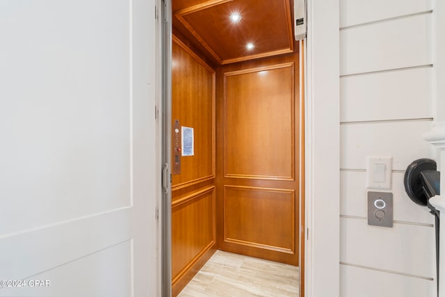 room details with hardwood / wood-style flooring and elevator