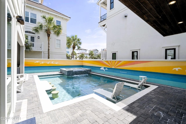 view of pool featuring a patio area and an in ground hot tub