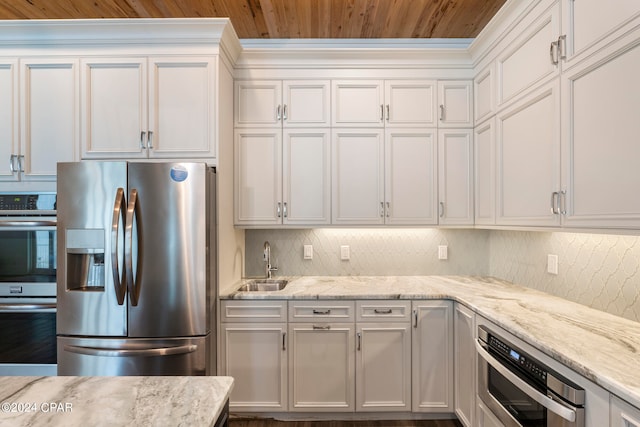 kitchen featuring backsplash, appliances with stainless steel finishes, sink, and white cabinets