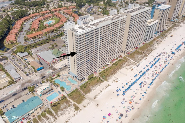 drone / aerial view with a water view and a beach view