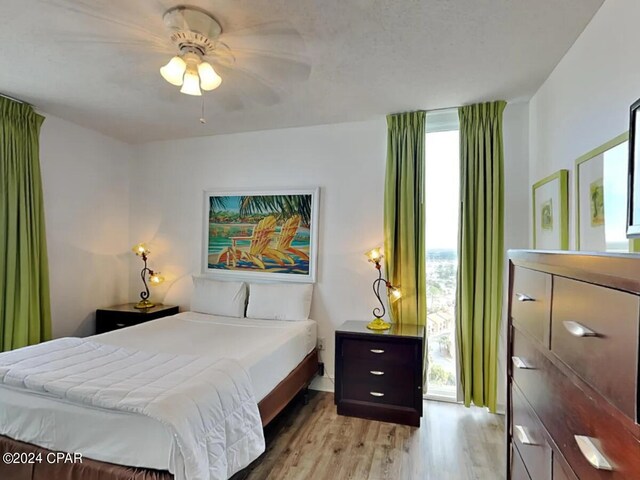 bedroom with ceiling fan and light wood-type flooring