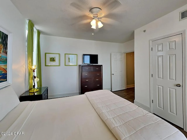 bedroom featuring ceiling fan and dark hardwood / wood-style flooring