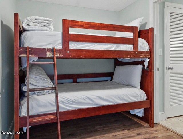 bedroom featuring hardwood / wood-style floors and a closet