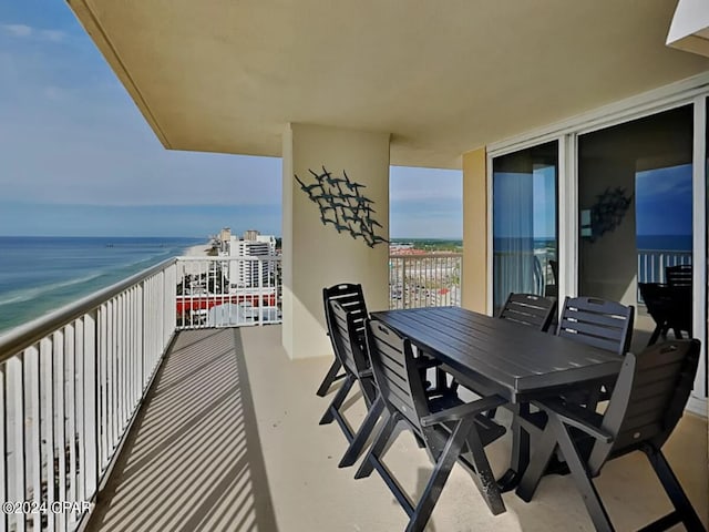 balcony featuring a water view and a view of the beach