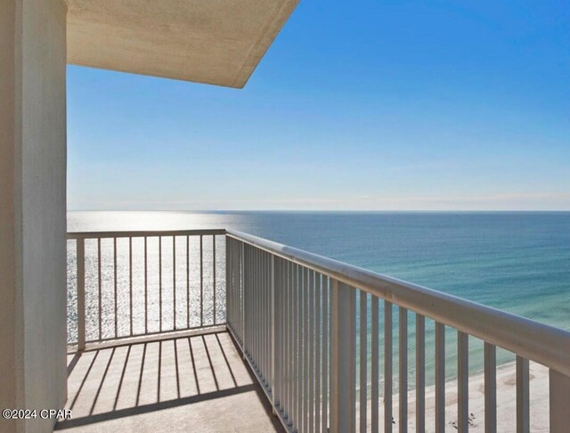 balcony with a water view and a beach view