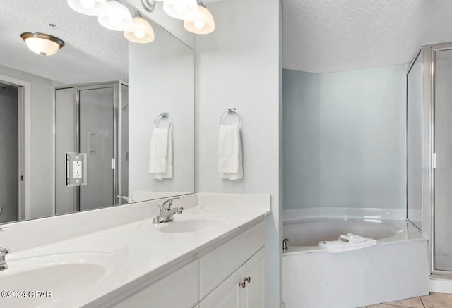 bathroom featuring double vanity, a textured ceiling, shower with separate bathtub, and tile patterned flooring