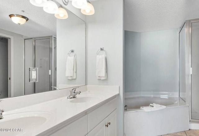 bathroom with vanity, tile patterned floors, a textured ceiling, and separate shower and tub