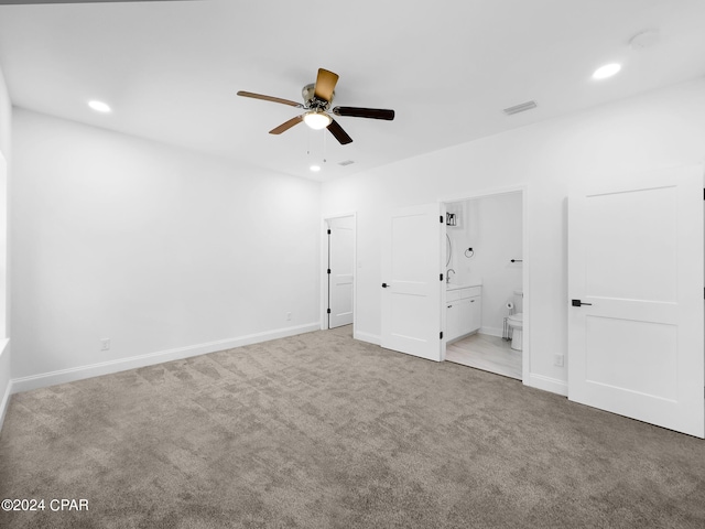 unfurnished bedroom featuring baseboards, carpet, ensuite bath, and recessed lighting