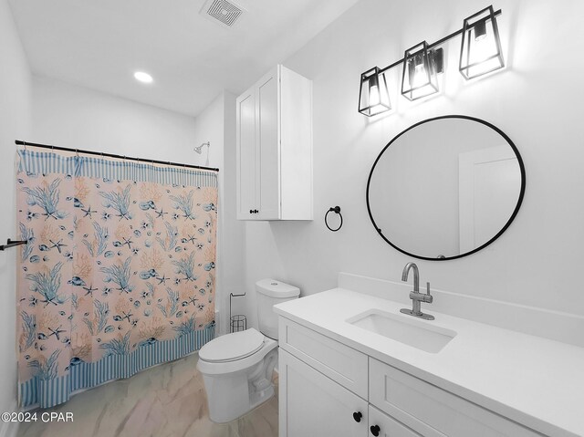 bathroom featuring vanity, toilet, and tile patterned floors