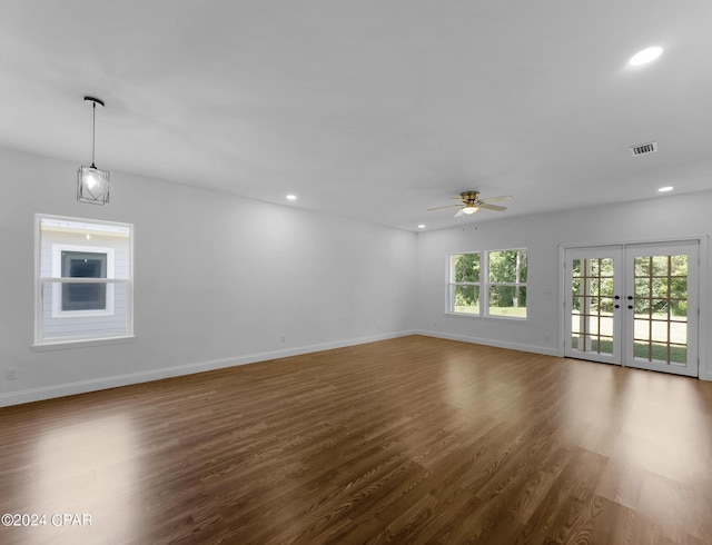 unfurnished living room featuring french doors, recessed lighting, visible vents, wood finished floors, and baseboards