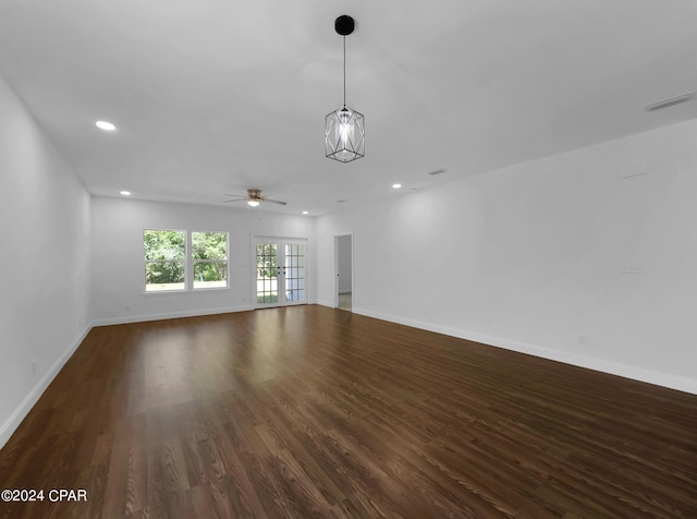 unfurnished living room with recessed lighting, visible vents, dark wood finished floors, and baseboards