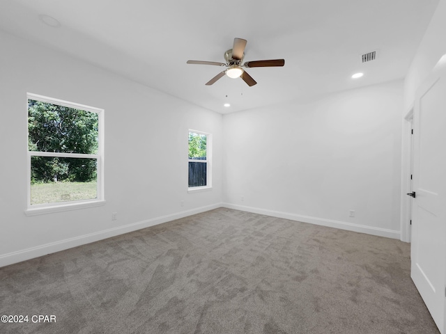 empty room featuring carpet floors, baseboards, visible vents, and recessed lighting