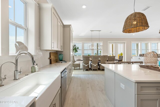 kitchen featuring decorative light fixtures, gray cabinets, and sink