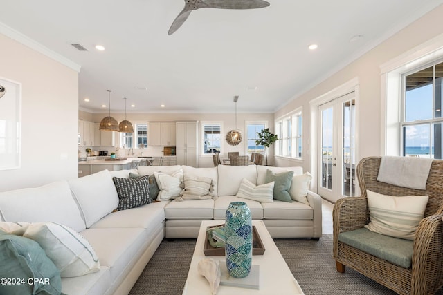 living room featuring ceiling fan and ornamental molding