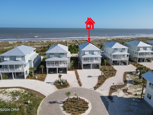 drone / aerial view with a beach view and a water view