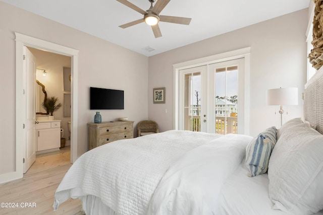 bedroom featuring access to exterior, french doors, ensuite bathroom, ceiling fan, and light hardwood / wood-style flooring