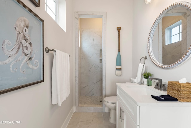 bathroom featuring toilet, vanity, and tiled shower