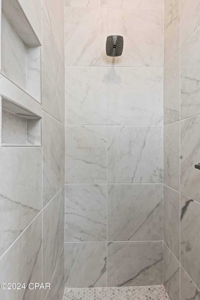 bathroom with tiled shower