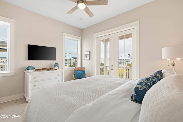 bedroom featuring access to exterior, light hardwood / wood-style floors, and ceiling fan