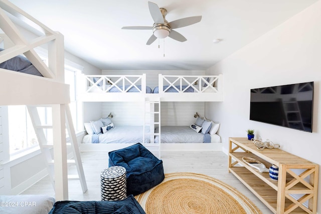 bedroom with multiple windows, lofted ceiling, and ceiling fan