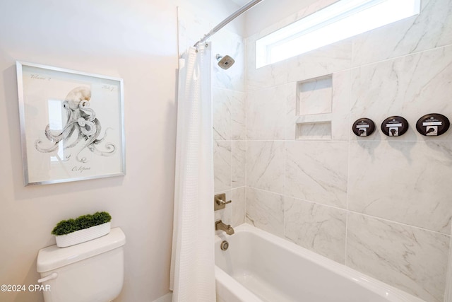 bathroom with shower / tub combo and toilet