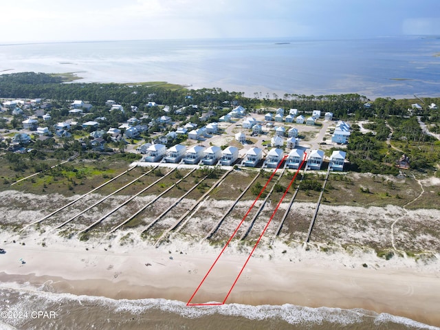 bird's eye view featuring a view of the beach and a water view